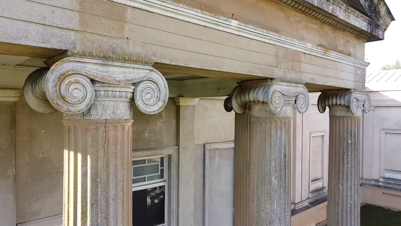 the outside of an old building with columns