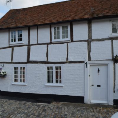 an old cottage which has recently had repair works carried out to the windows and the outside painted