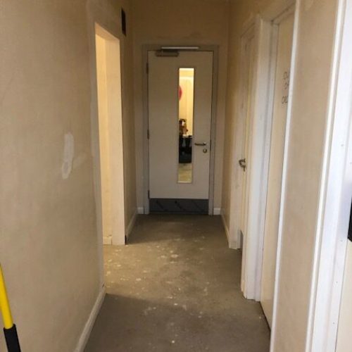 a corridor with new doors fitted and decoration works taking place