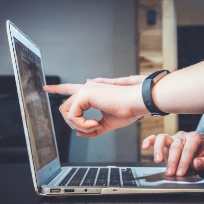 people looking a laptop and discussing a project